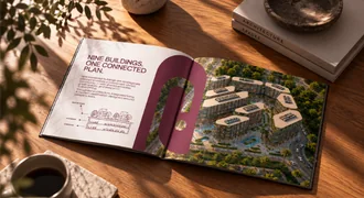 The Intro brochure open on a café table, presenting nine buildings as one connected plan.
